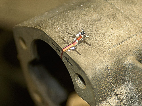 Fixing a hairline crack in cast iron requires drilling the crack end