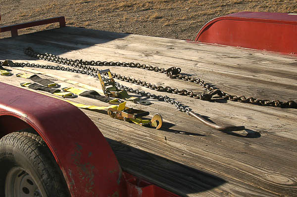 Chains and straps for safe tie-down.