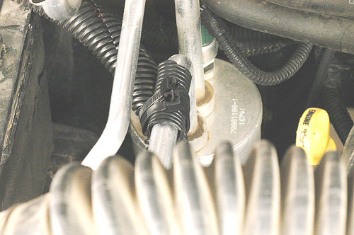 Sleeved winch cables attached to the air conditioning tube.