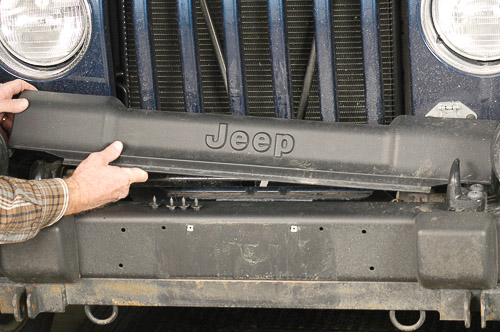 Remove Jeep TJ Wrangler cover over stabilizer bar.